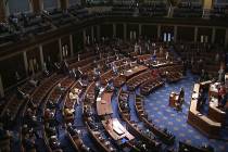 In this image from video, members of the House practice social distancing as they sit on the fl ...