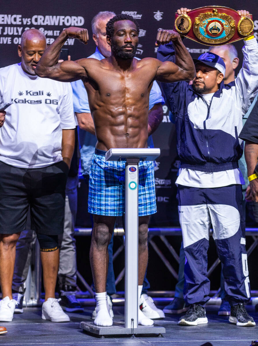 Boxer Terence Crawford flexes while on the scale during his weigh in ahead of the fight against ...