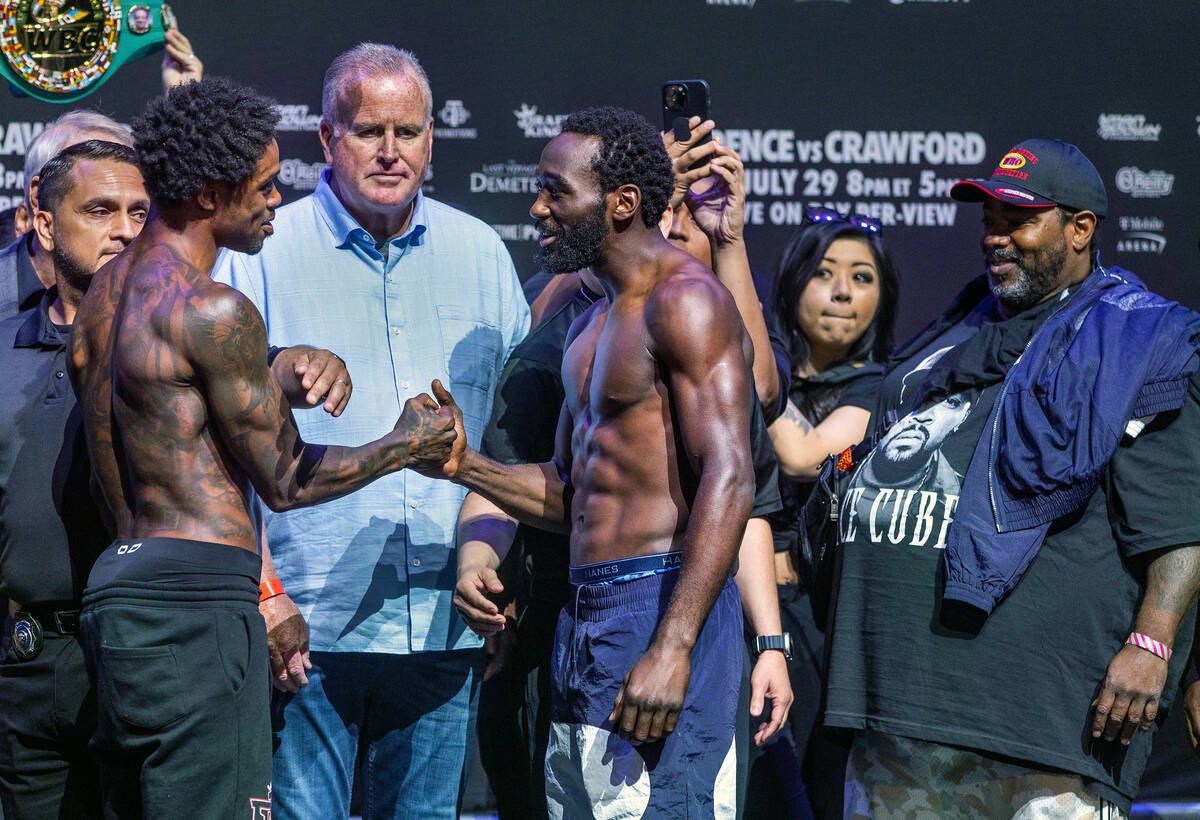 Boxers Errol Spence Jr. and Terence Crawford shake hands as they come together for a face off f ...