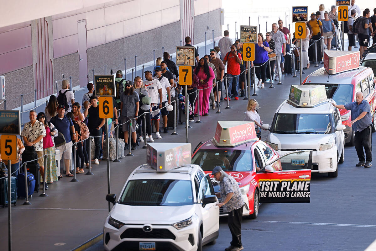 People wait for riding taxies at Harry Reid International Airport, Friday, June 30, 2023, in La ...