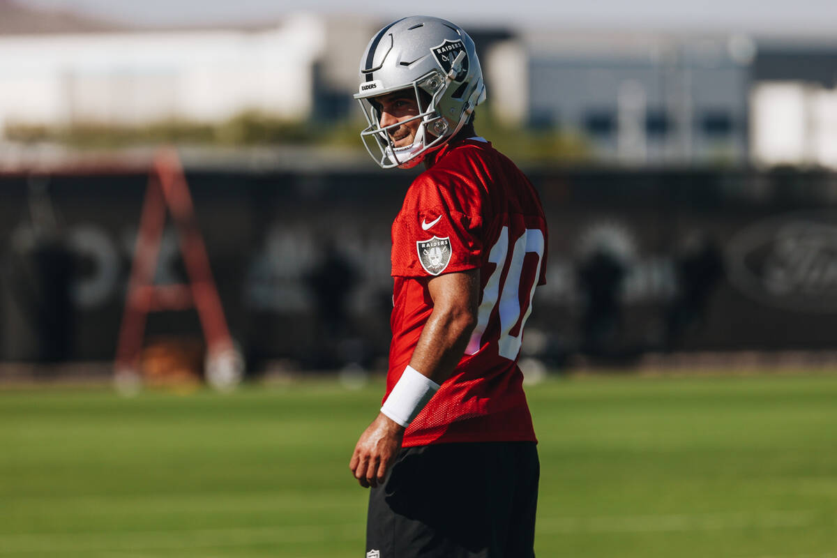 Raiders quarterback Jimmy Garoppolo smiles at a teammate during training camp at the Intermount ...