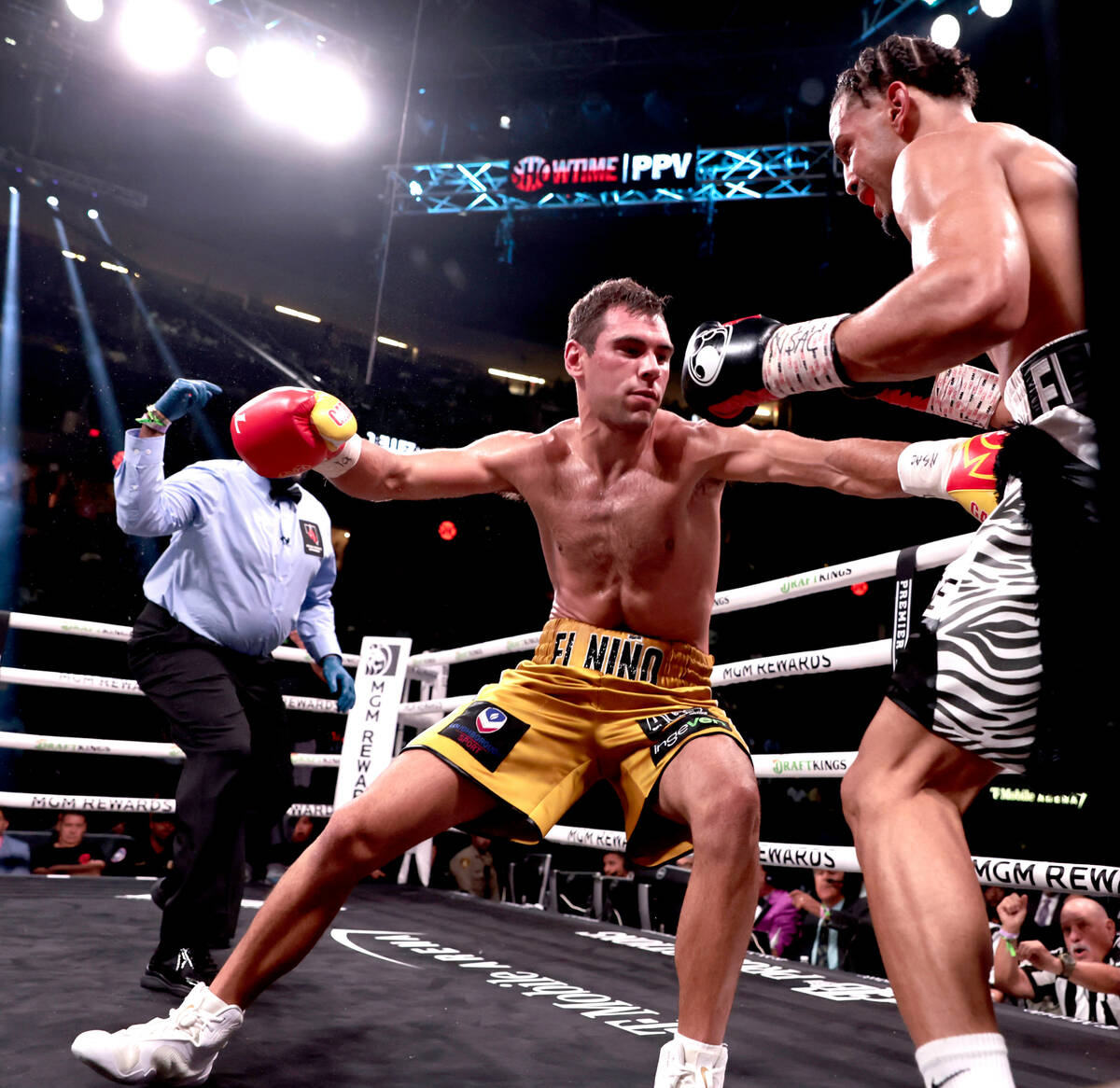Boxer Yoenis Tellez, right, sends Sergio Garcia stumbling during round 3 in a super welterweigh ...