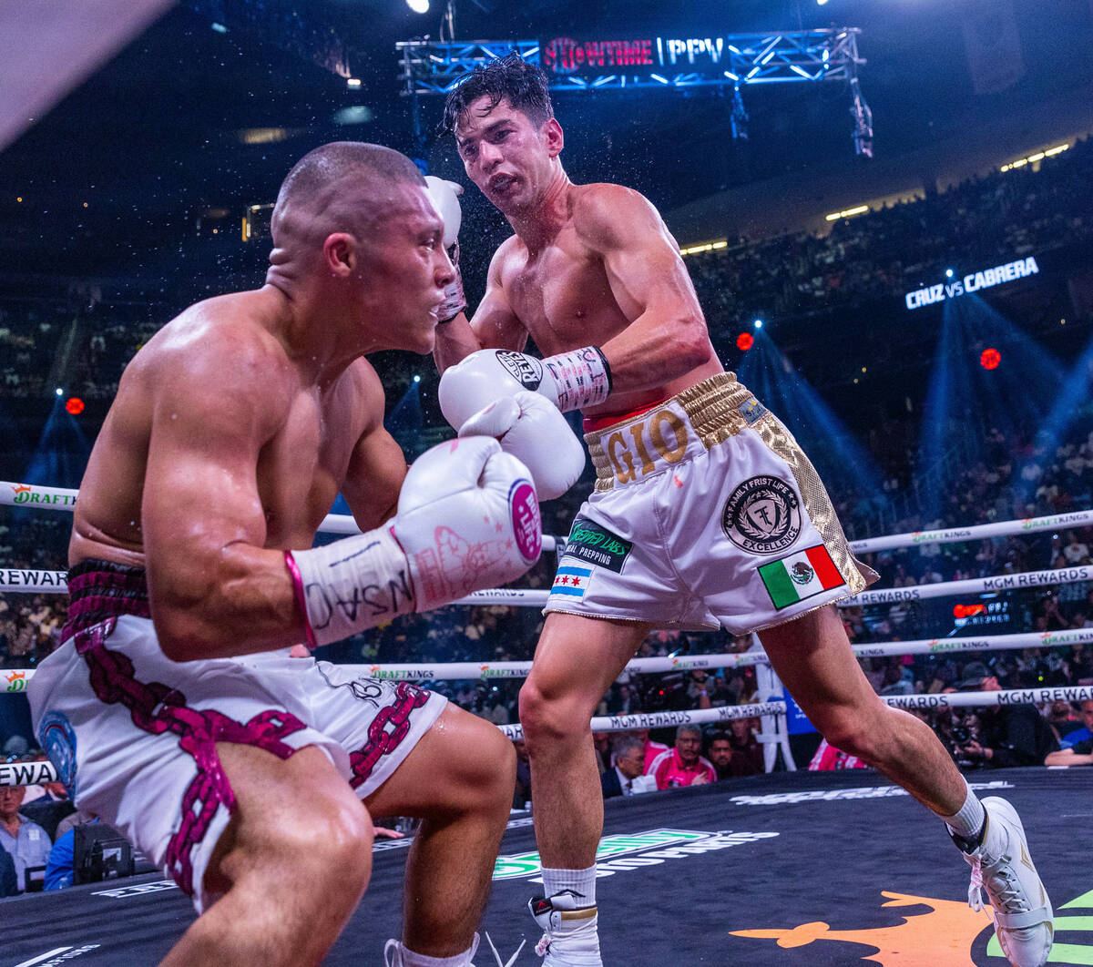 Isaac Cruz is rocked back with a shot by Giovanni Cabrera in round 7 during world welterweight, ...