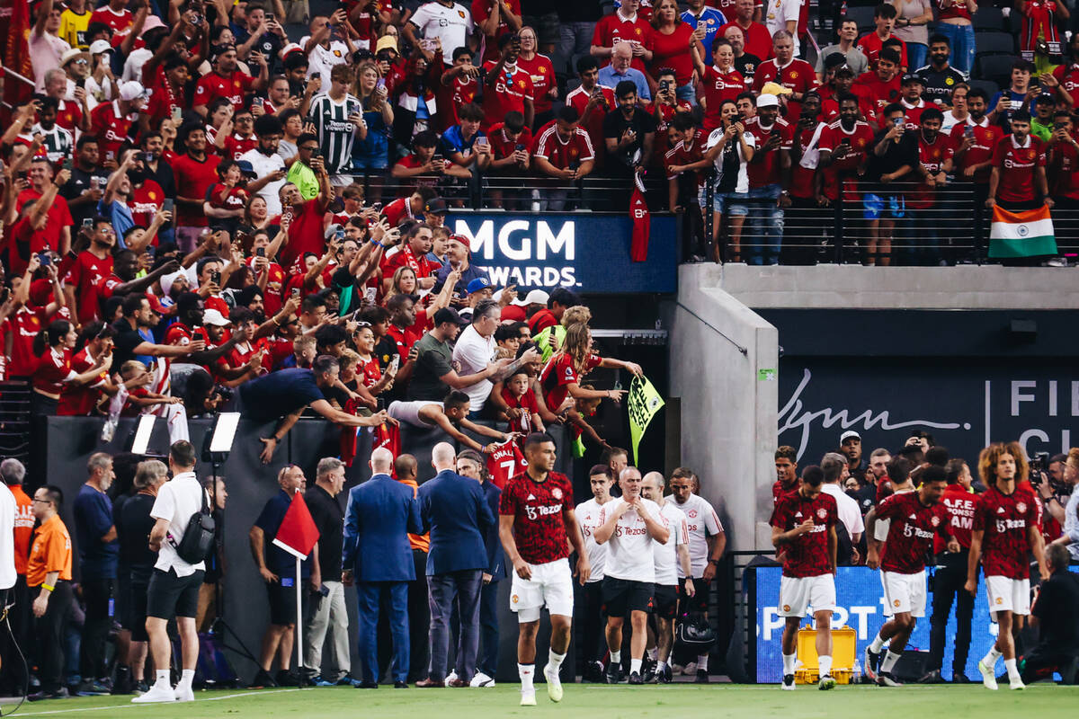 Manchester United fans go wild as the team enters the stadium to warm up before a match up agai ...