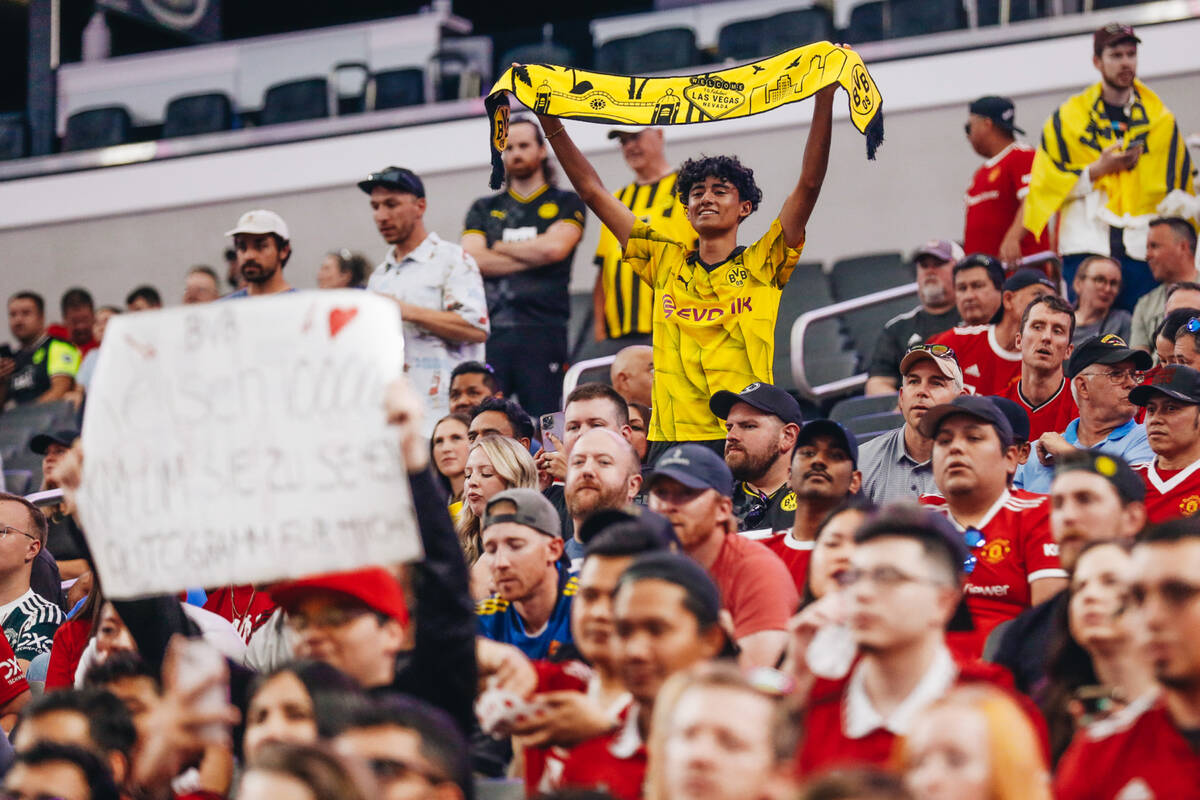 A Borussia Dortmund fan waves a team scarf in the air during a match against Manchester United ...