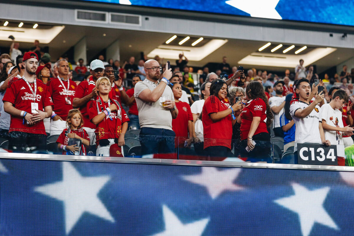 Manchester United fans listen to the national anthem before a match up against Borussia Dortmun ...