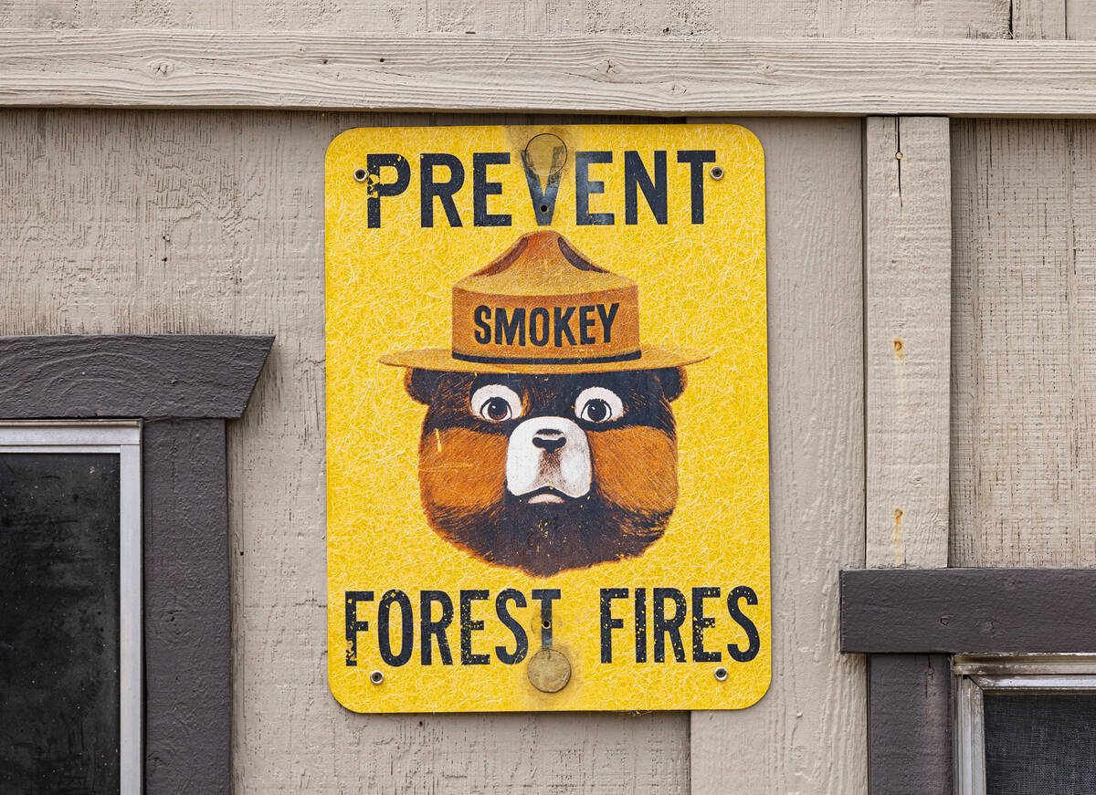 A sign that reads "Prevent Smokey Forest Fire" is posted on a house, on Monday, July ...