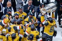 Golden Knights right wing Mark Stone (61) hoists the Stanley Cup before teammates defeating the ...