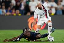 Real Madrid FC midfielder Aurelien Tchouameni, left, and AC Milan forward Olivier Jonathan Giro ...