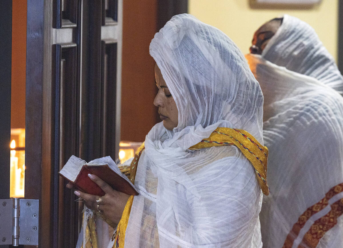 A worshipper reads a bible during mass at Hamere Noah Kidane Mehret and St Michael Ethiopian Or ...