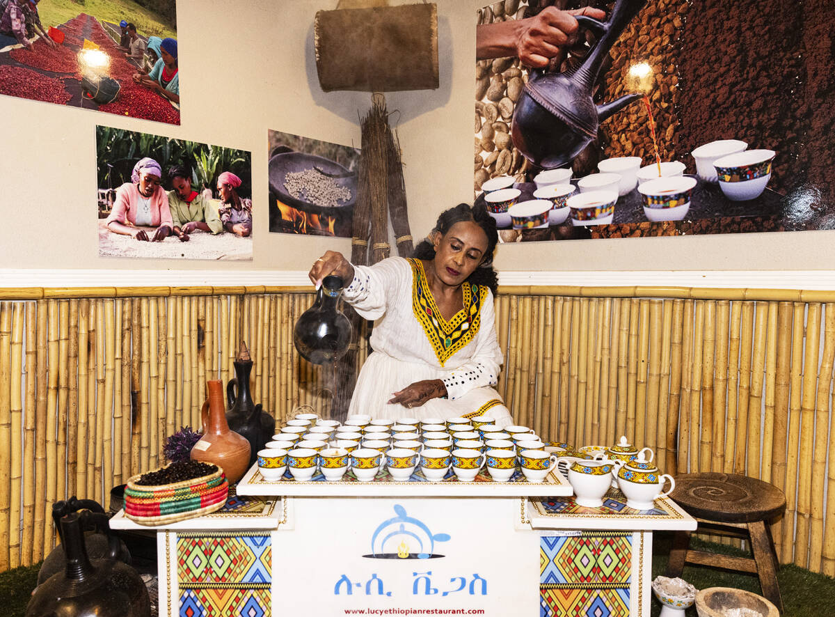 Aster Yoseph pours roasted coffee, prepared in a traditional Ethiopian ceremony, at Lucy Ethiop ...