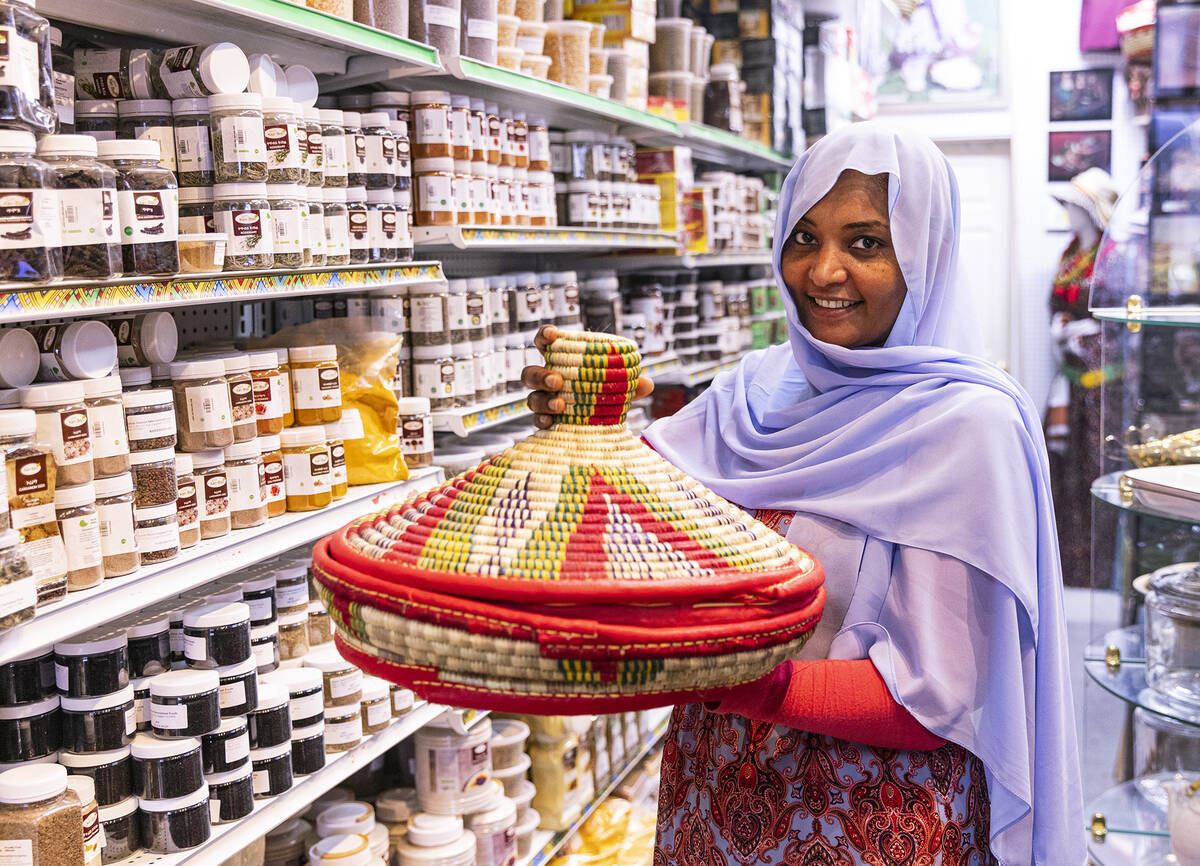 Unity Ethiopian Market co-owner Fatuma Mengesh, holding a Mesob, poses for a photo a her Las Ve ...