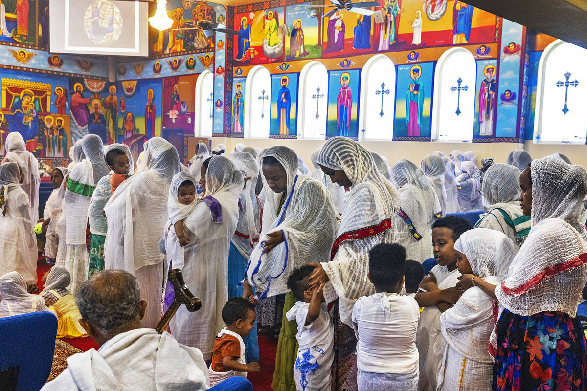 Worshippers line up to receive communion at Hamere Noah Kidane Mehret and St Michael Ethiopian ...