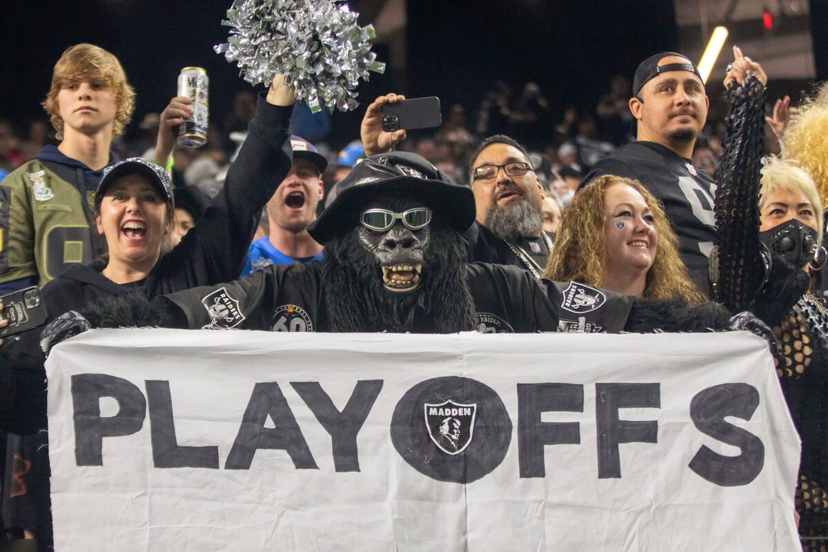 Raiders superfan Gorilla Rilla holds up a playoffs sign in the Black Hole after the team beat t ...