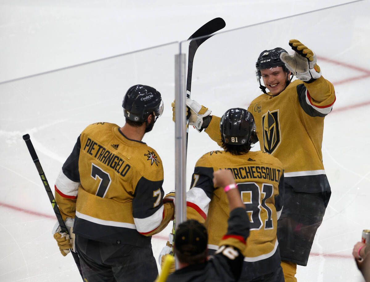 Golden Knights right wing Jonathan Marchessault (81) celebrates with Golden Knights left wing P ...