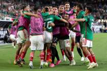 Mexico celebrates after winning a CONCACAF Gold Cup semifinal soccer match against Jamaica at A ...