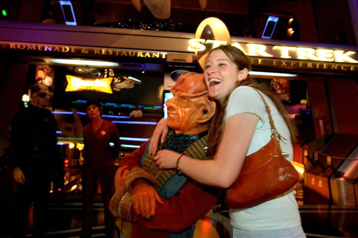 Tracy Jackson of Los Angeles hugs an actor dresses as a Ferengi inside "Star Trek The Experienc ...