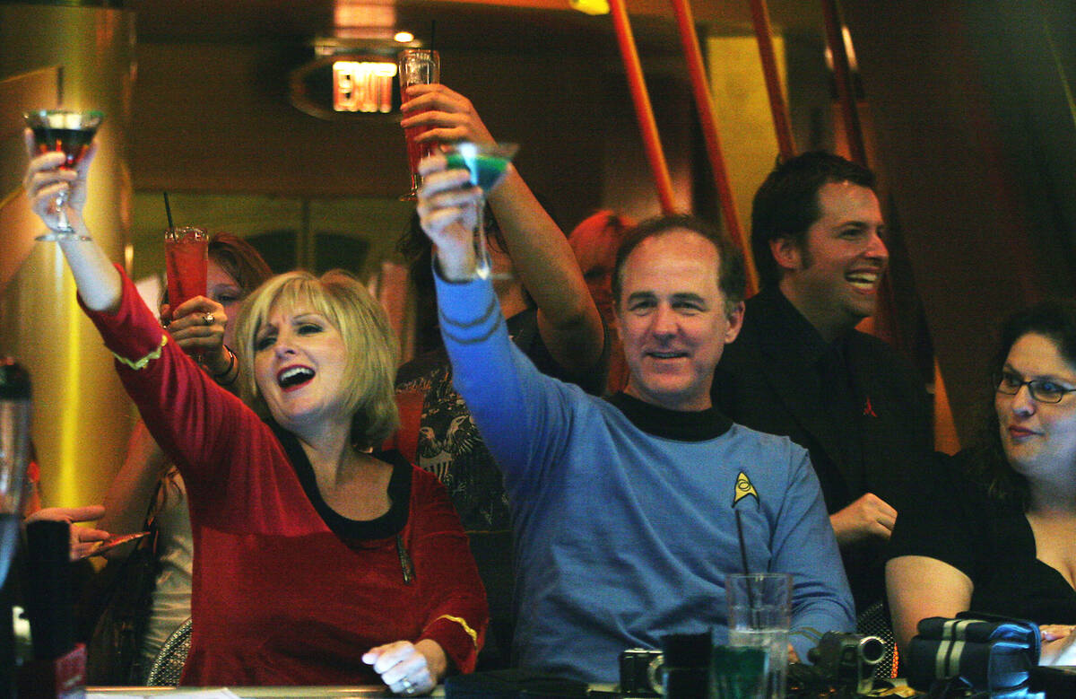 Pat and Bill Lyons, visiting from Lincoln, California, raise their glasses at Quark's Bar & Res ...
