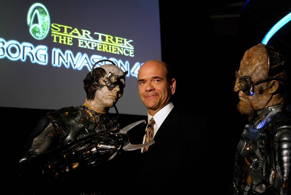Actor Robert Picardo poses with Borg during a press conference announcing "Borg Invasion 4D" at ...