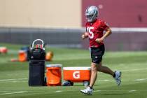 Raiders quarterback Chase Garbers (15) runs during the Raiders’ organized team activitie ...