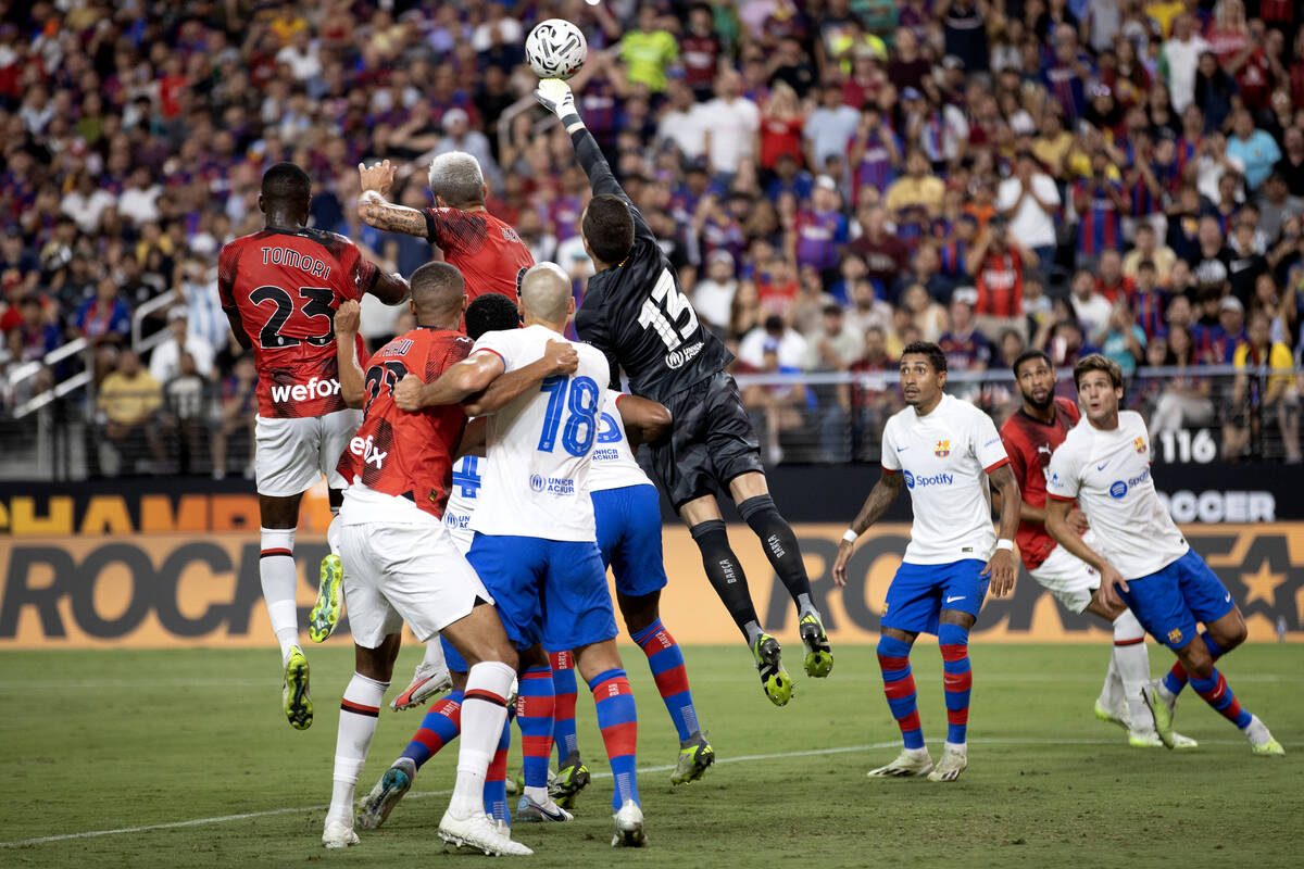 Barcelona goalkeeper Iñaki Peña (13) jumps to save against Milan during the first half of a S ...