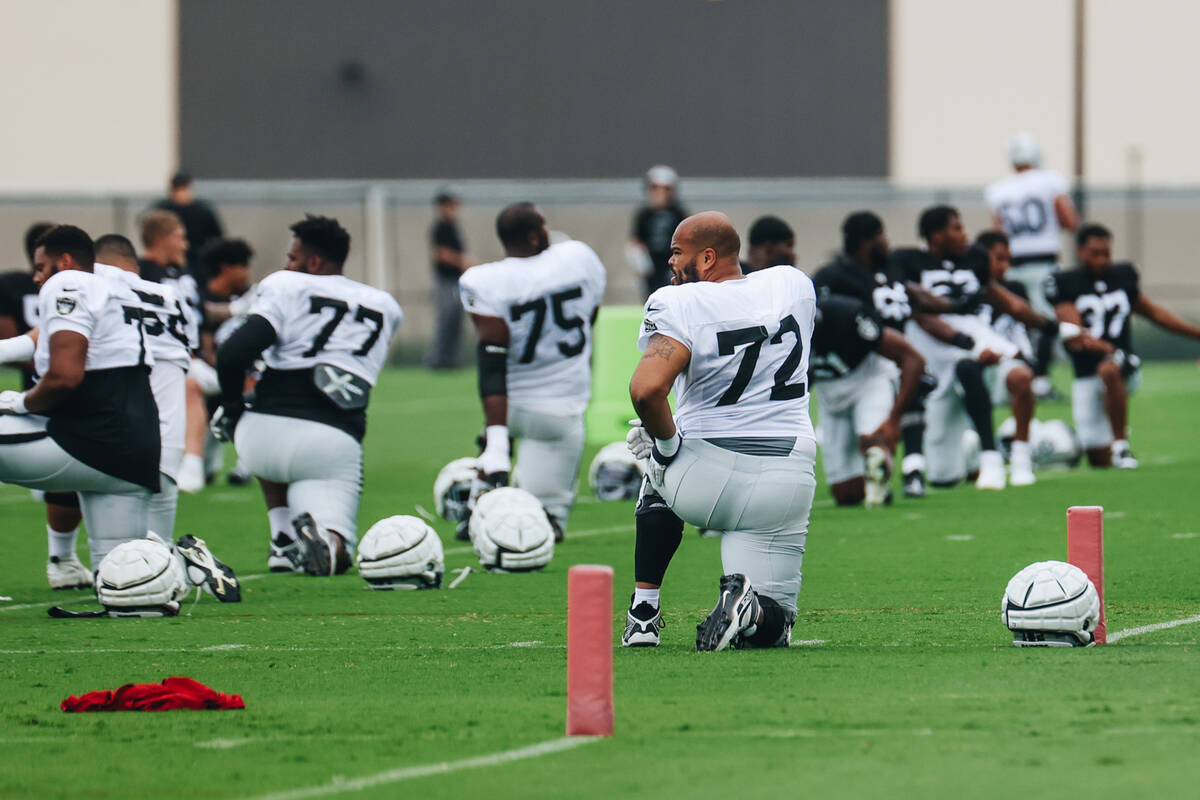 Raiders offensive tackle Jermaine Eluemunor (72) stretches with his teammates during training c ...