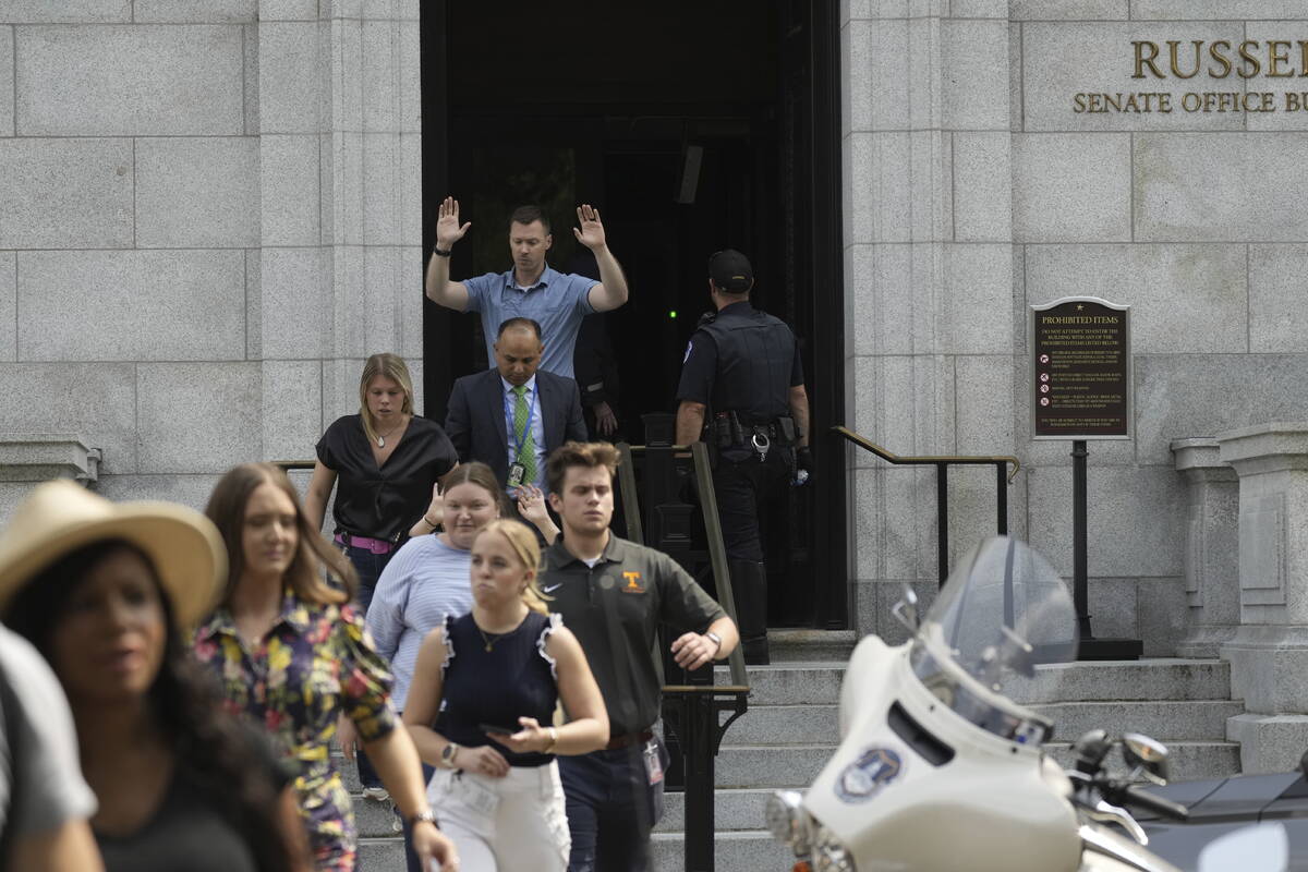 Government staffers walk out of the Russell Senate Office Building on Wednesday, Aug. 2, 2023, ...