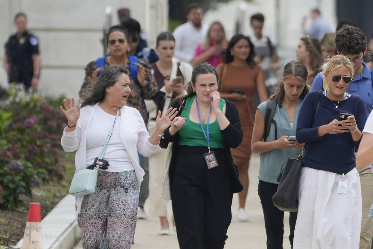 People exit near the Russell Senate Office Building on Wednesday, Aug. 2, 2023, in Washington. ...