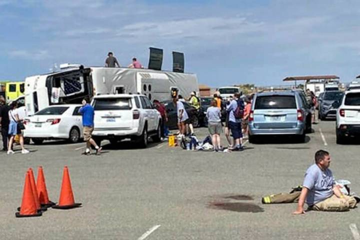 Emergency personnel tend to a crash after a tour bus rolled over near the Grand Canyon West Sky ...