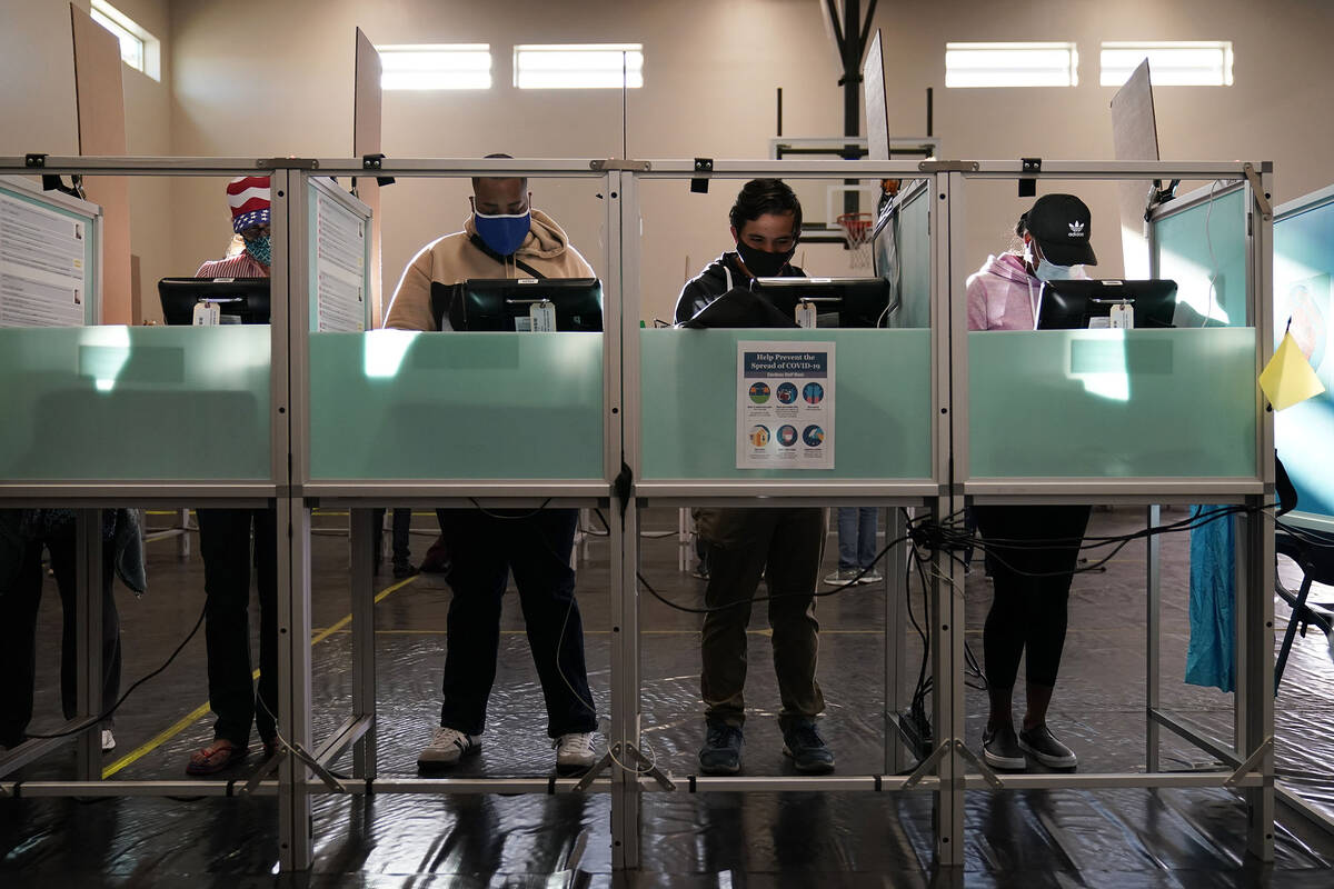 People vote at a polling place on Election Day on Nov. 3, 2020, in Las Vegas. According to new ...