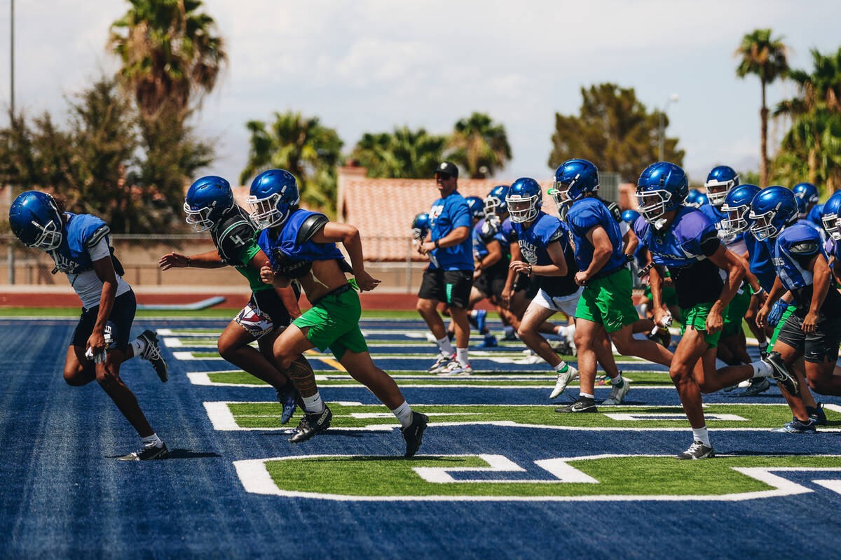 Green Valley football players run down the field during a drill at practice at Green Valley Hig ...