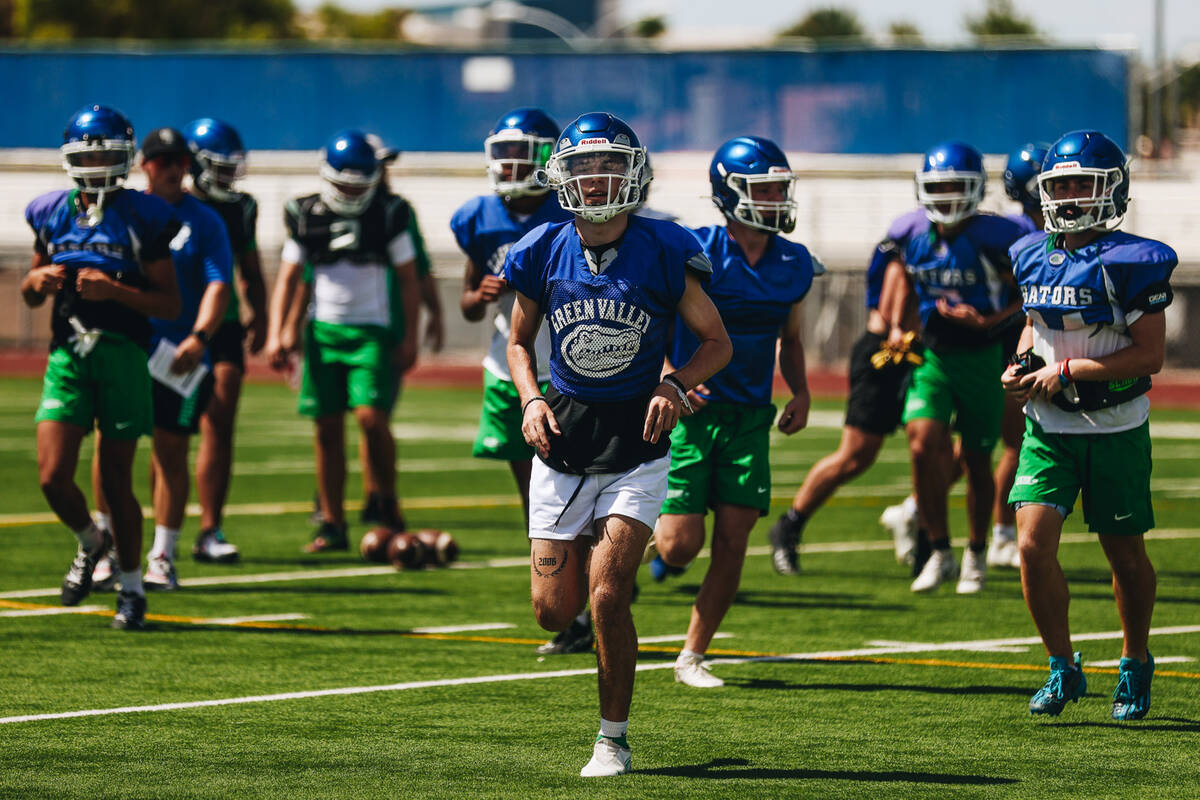 Green Valley football players run down the field during a drill at practice at Green Valley Hig ...