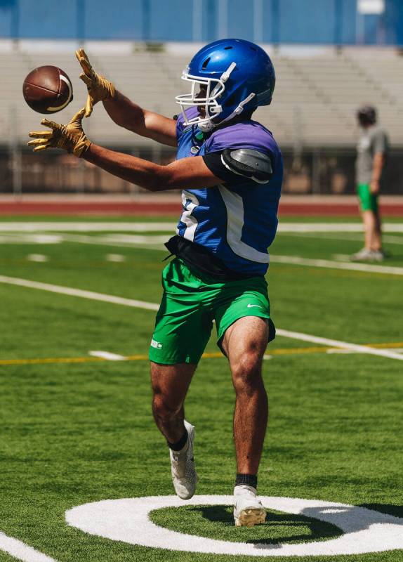A Green Valley football player catches the ball during a drill at practice at Green Valley High ...