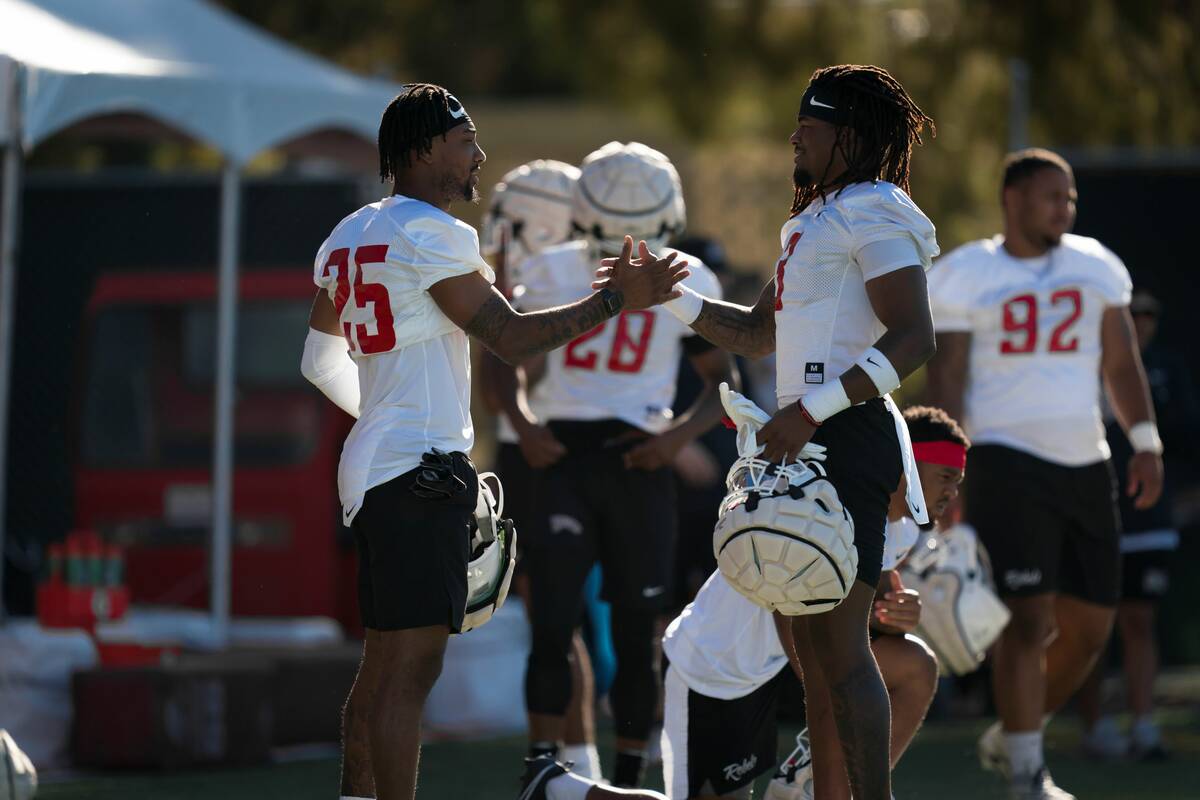 UNLV safety Johnathan Baldwin, right, greets safety Jordyn Morgan before the first practice of ...