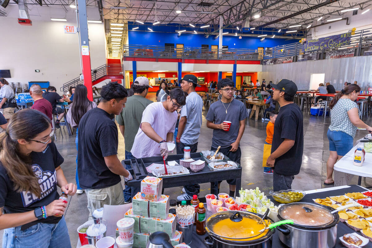 A crowd gathers during a food and drink fundraiser for the family of Angel Naranjo at the Equip ...