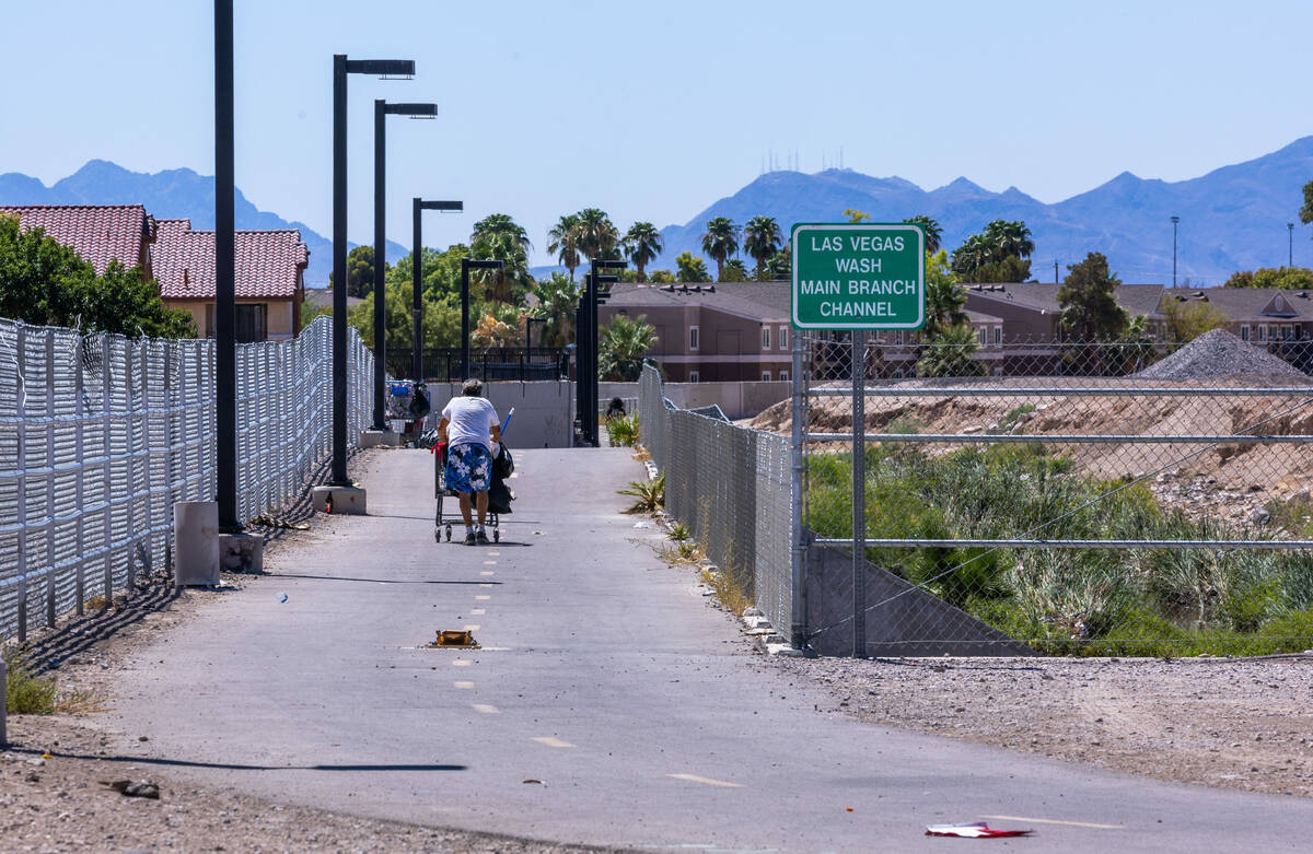 A man walks down the paved trail near where Angel Naranjo was killed on his minibike next to th ...