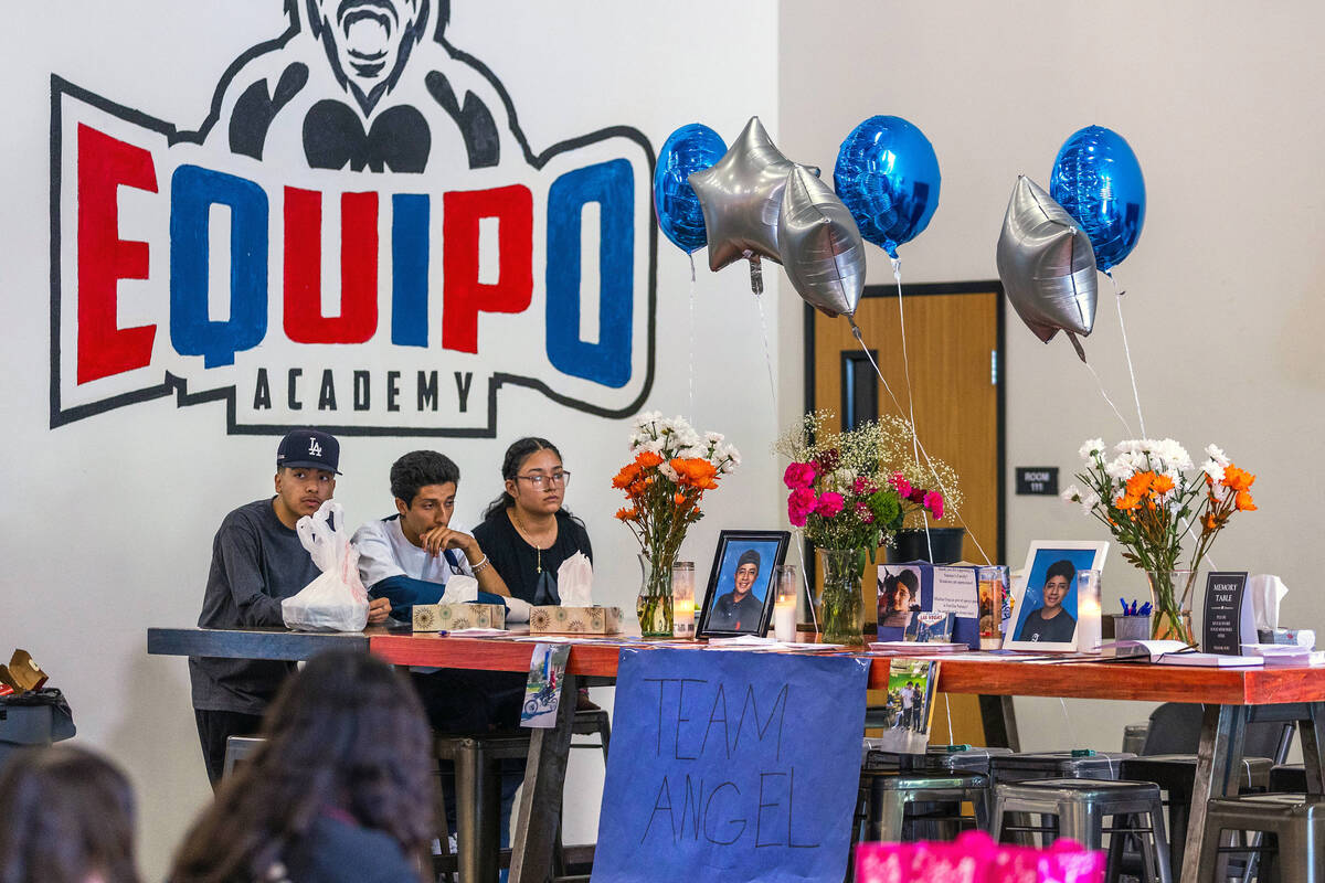 Mourners sit at a memorial table of items from Angel Naranjo during a food and drink fundraiser ...