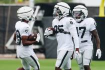 Raiders running back Zamir White (35) goes through a drill with his teammates during training c ...