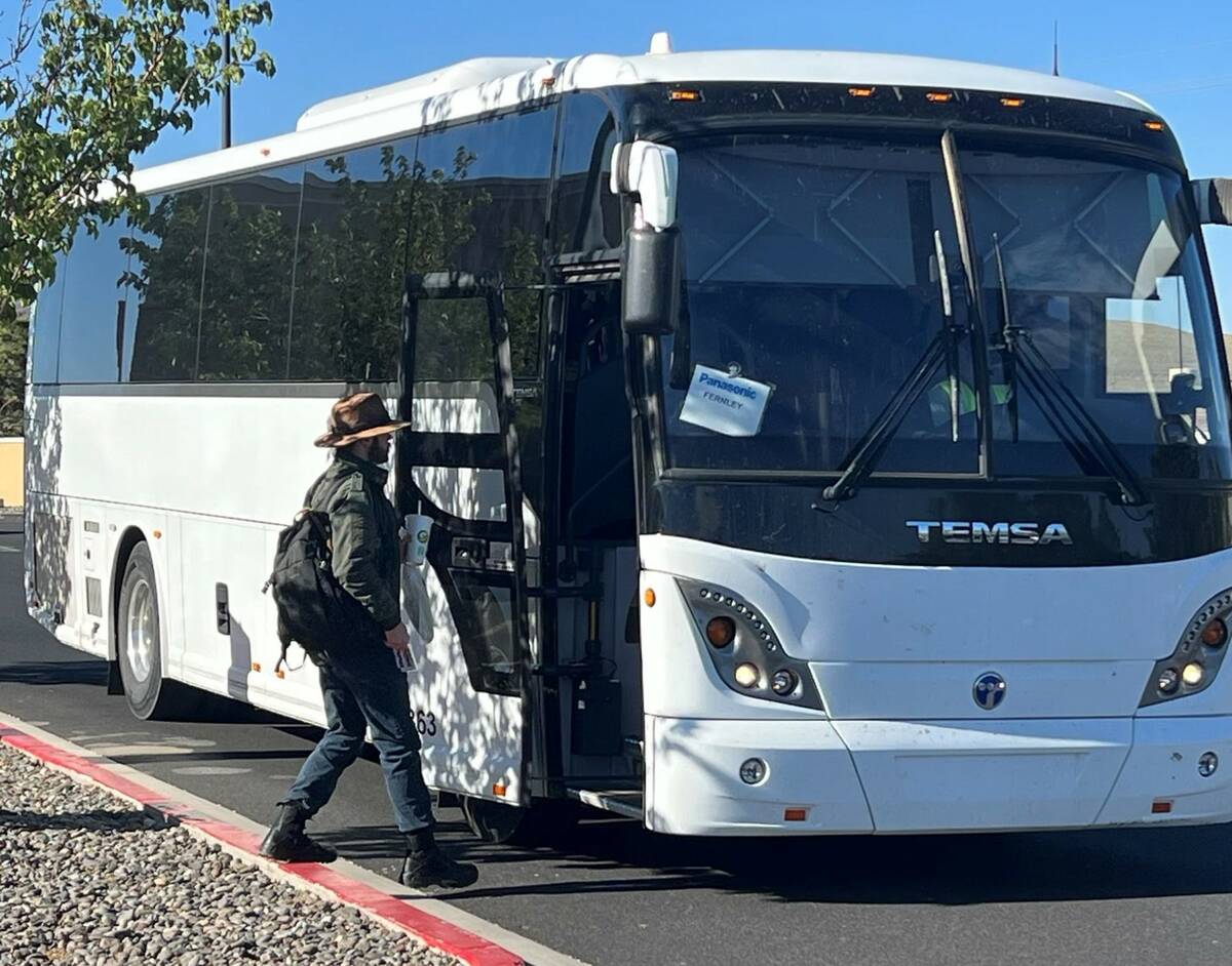 A worker boarding the Panasonic shuttle bus at the Walmart parking lot in Fernley in July 2023. ...