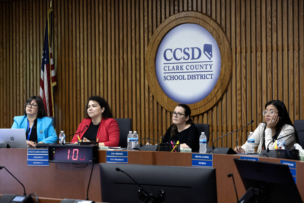 Clark County School District Board trustees Irene Bustamante Adams, left, Evelyn Garcia Morales ...