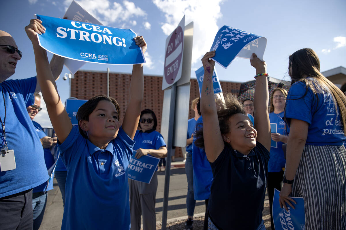 CCSD students Preston Hensley, 10, left, and Lynkin Smith, 9, protest with their parents, who a ...