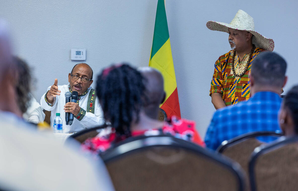 Little Ethiopia project chair Girma Zaid speaks to the group as Teklu Tesfaye looks on during a ...
