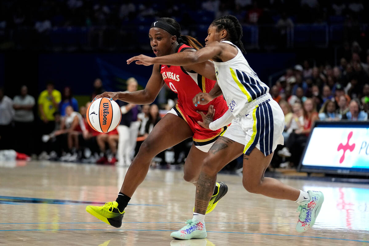 Las Vegas Aces guard Jackie Young (0) drives against Dallas Wings' Crystal Dangerfield during t ...
