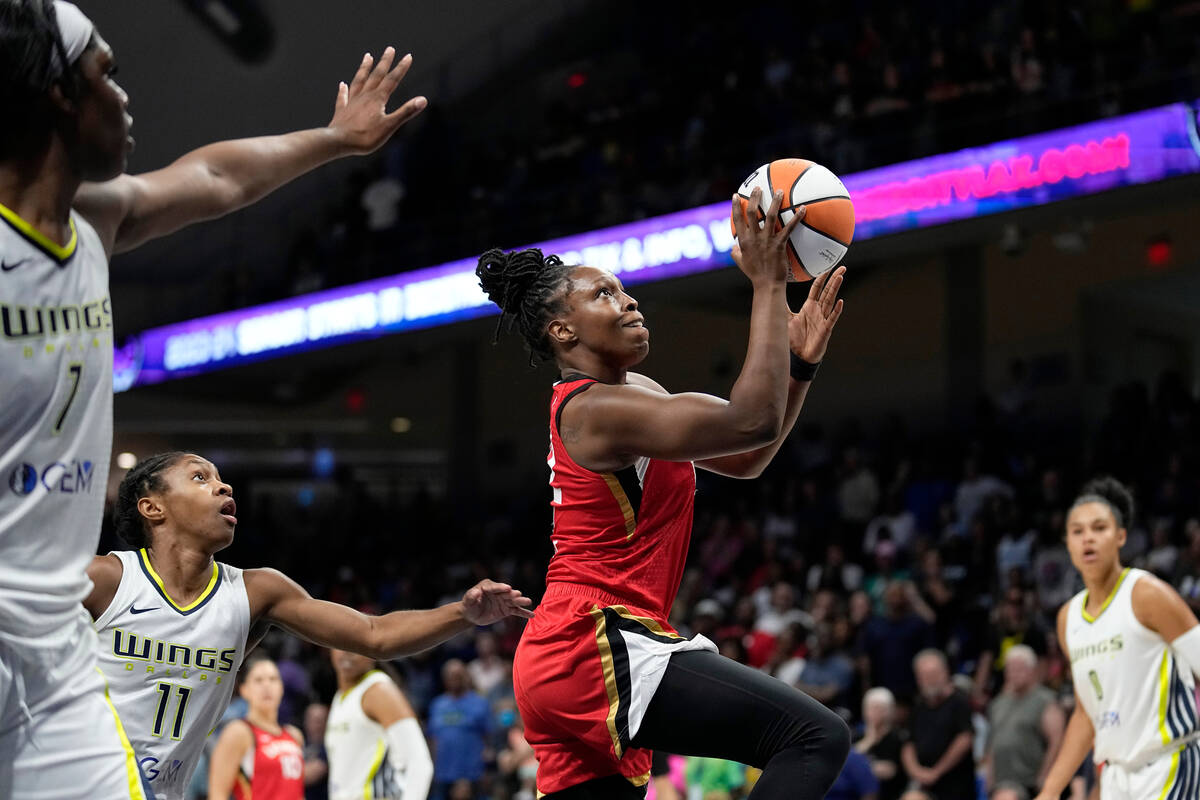 Las Vegas Aces guard Chelsea Gray shoots after getting past Dallas Wings defenders Teaira McCow ...