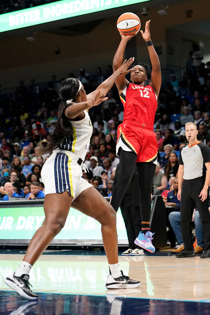 Las Vegas Aces guard Chelsea Gray (12) shoots over Dallas Wings center Kalani Brown during the ...
