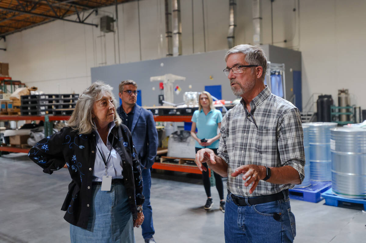 Dr. James Hodge, vice president of power sources, right, leads Rep. Dina Titus, D-Nev., left, o ...
