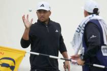 United States' Xander Schauffele reacts after putting on the 2nd green during the final day of ...