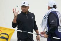 United States' Xander Schauffele reacts after putting on the 2nd green during the final day of ...