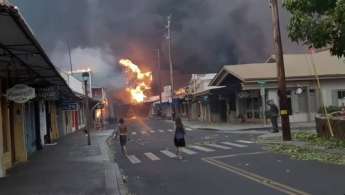 CORRECTS DATE TO AUG. 8 - People watch as smoke and flames fill the air from raging wildfires o ...