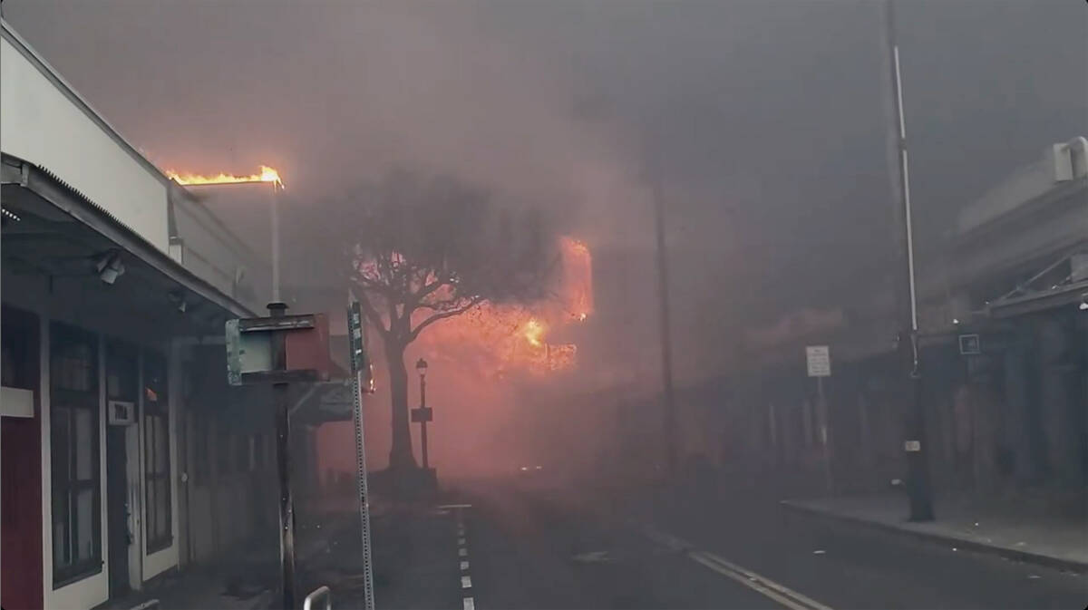 CORRECTS DATE TO AUG. 8 - Smoke and flames fill the air from raging wildfires on Front Street i ...